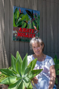 Heather poses with new sign for Amayz Mosaics Sunshine Coast